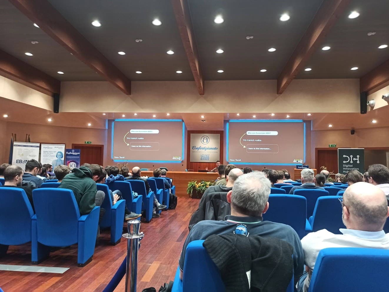 Large lecture hall filled with engaged developers
